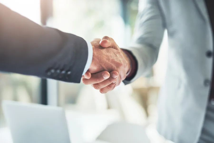 Two business people shaking hands on a deal