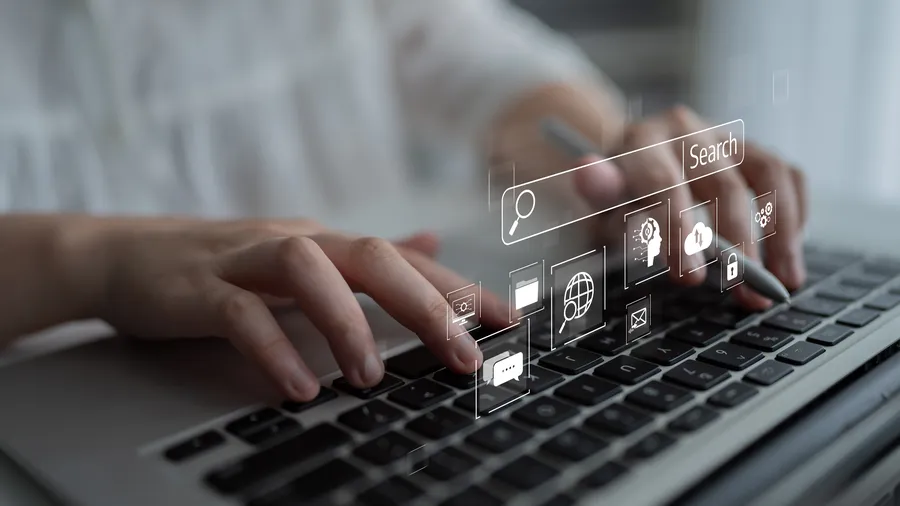 Search bar and digital marketing icons floating over a laptop keyboard